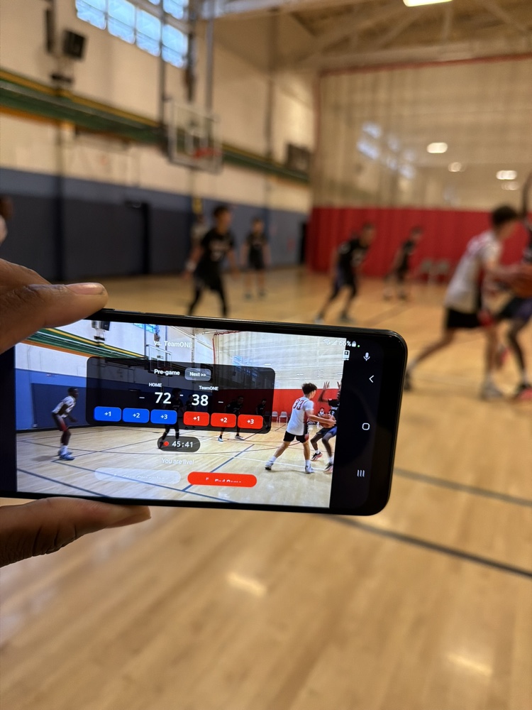 A phone streaming a live game courtside, score 72 to 38, live in the app