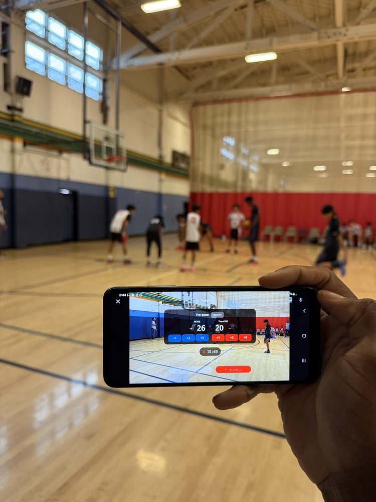 A hand holding a phone at the game, streaming live